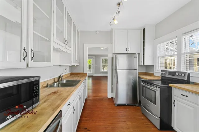 a kitchen with a sink stove and refrigerator