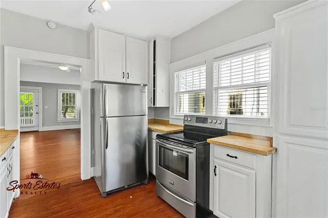 a kitchen with a stove a refrigerator and a sink