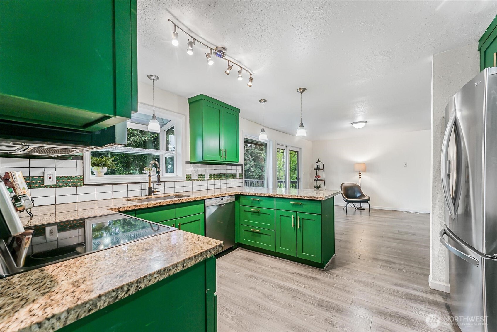 11404 Karshner Road East Edgewood, WA 98372 - Photo 12 of 40 a kitchen with lots of counter top space and a chandelier