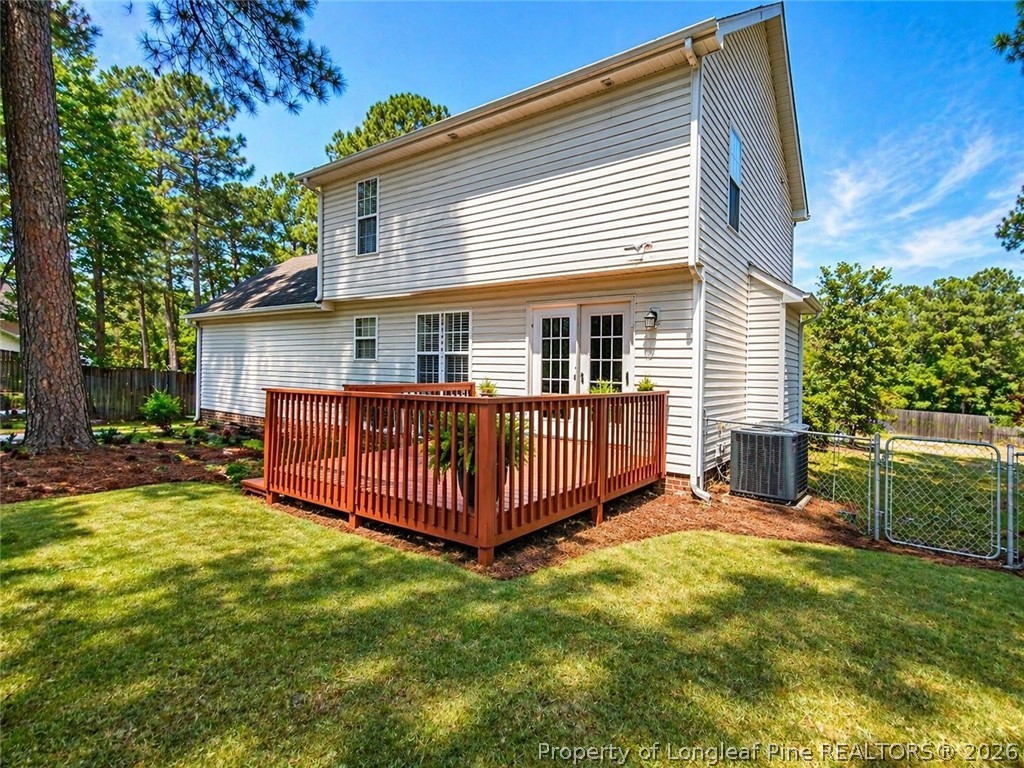 1050 Roundabout Road Cameron, NC 28326 - Photo 8 of 8 a view of a house with a yard and deck area with a garden