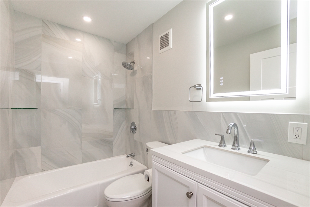 31 Hamlin Lane, Unit A33 Needham, MA 02492 - Photo 11 of 15 a bathroom with a sink a toilet and a bathtub