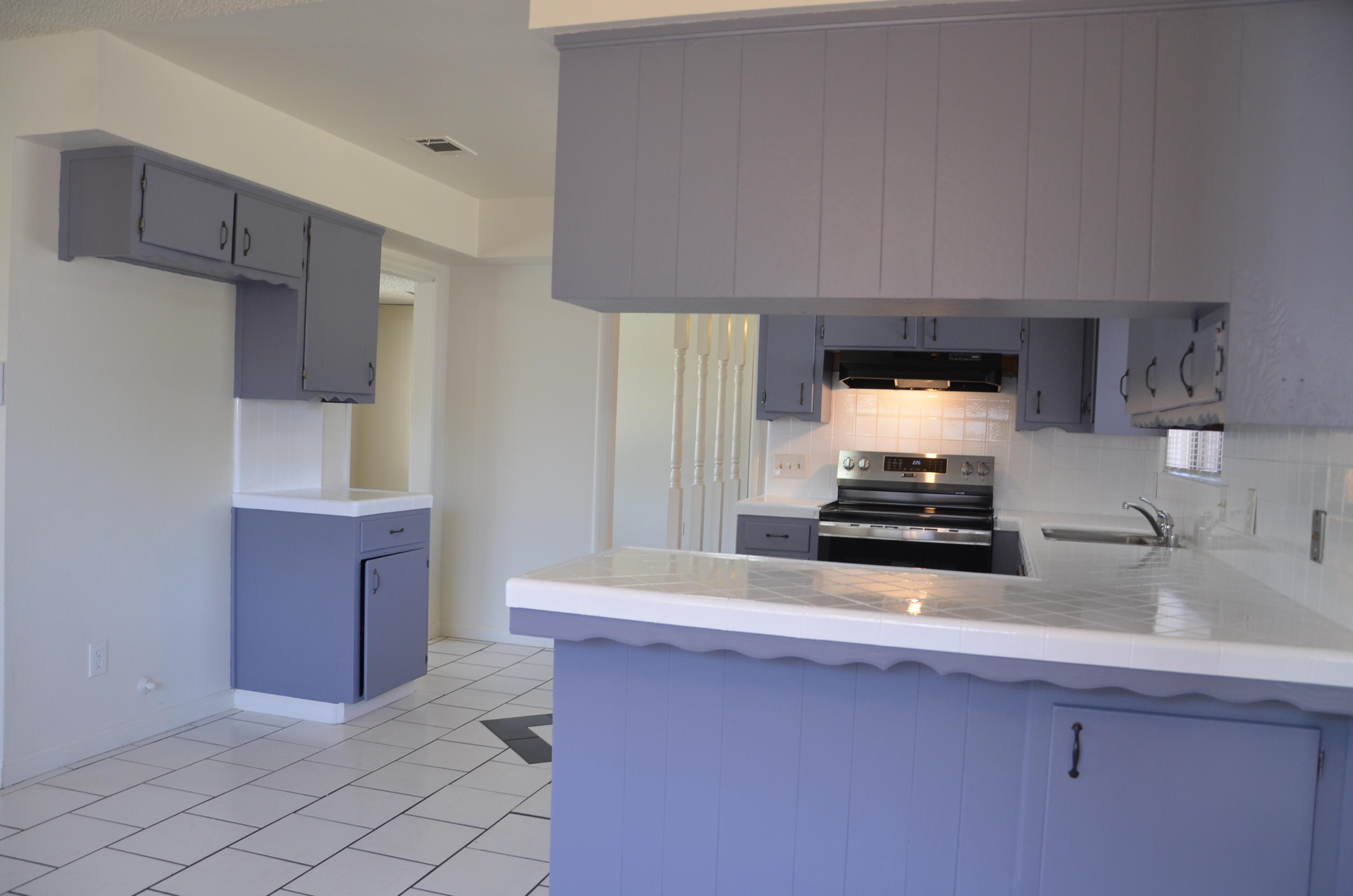 339 West Spring Lane Lemoore, CA 93245 - Photo 9 of 31 a kitchen with wooden cabinets and a sink