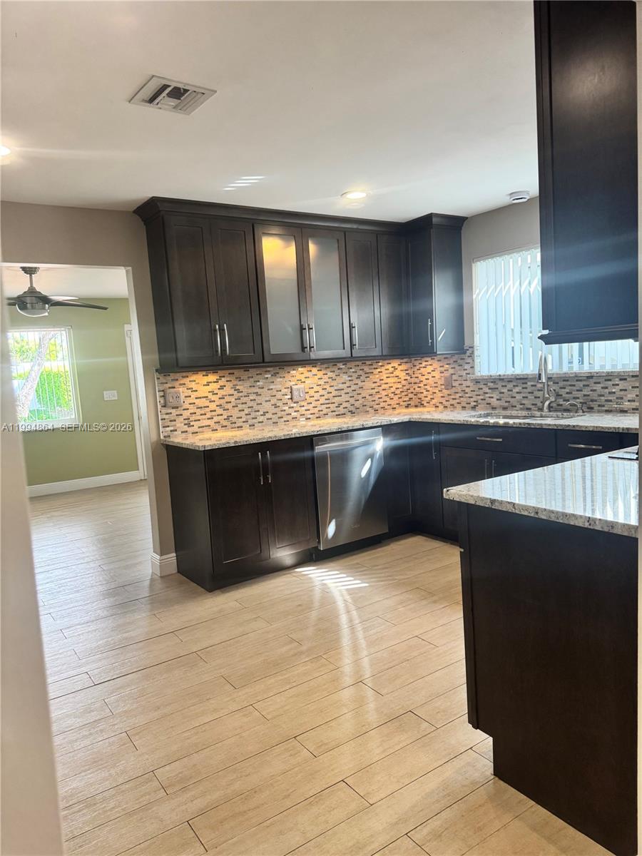 10760 Southwest 63rd Street Miami, FL 33173 - Photo 15 of 61 a large kitchen with granite countertop a sink and a stove