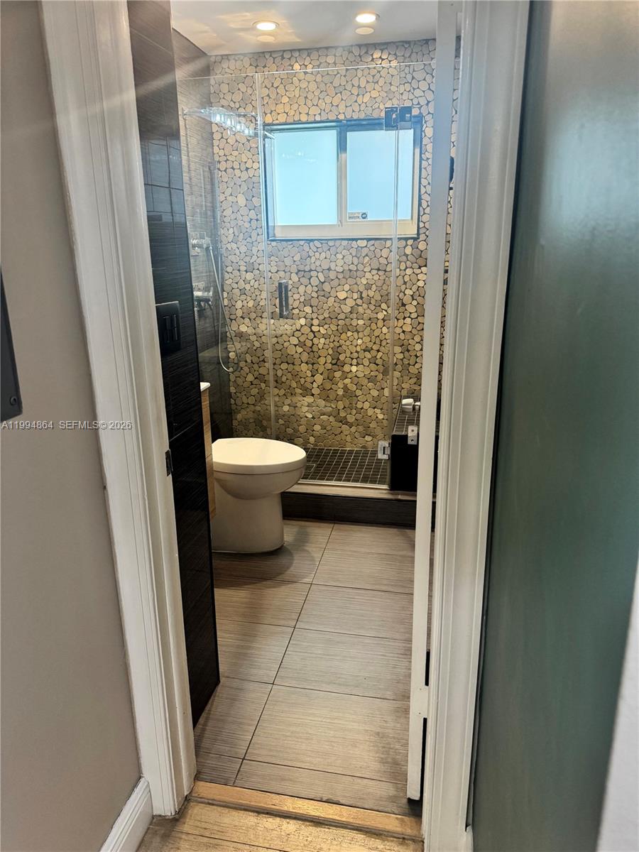 10760 Southwest 63rd Street Miami, FL 33173 - Photo 22 of 61 a bathroom with a toilet and a shower