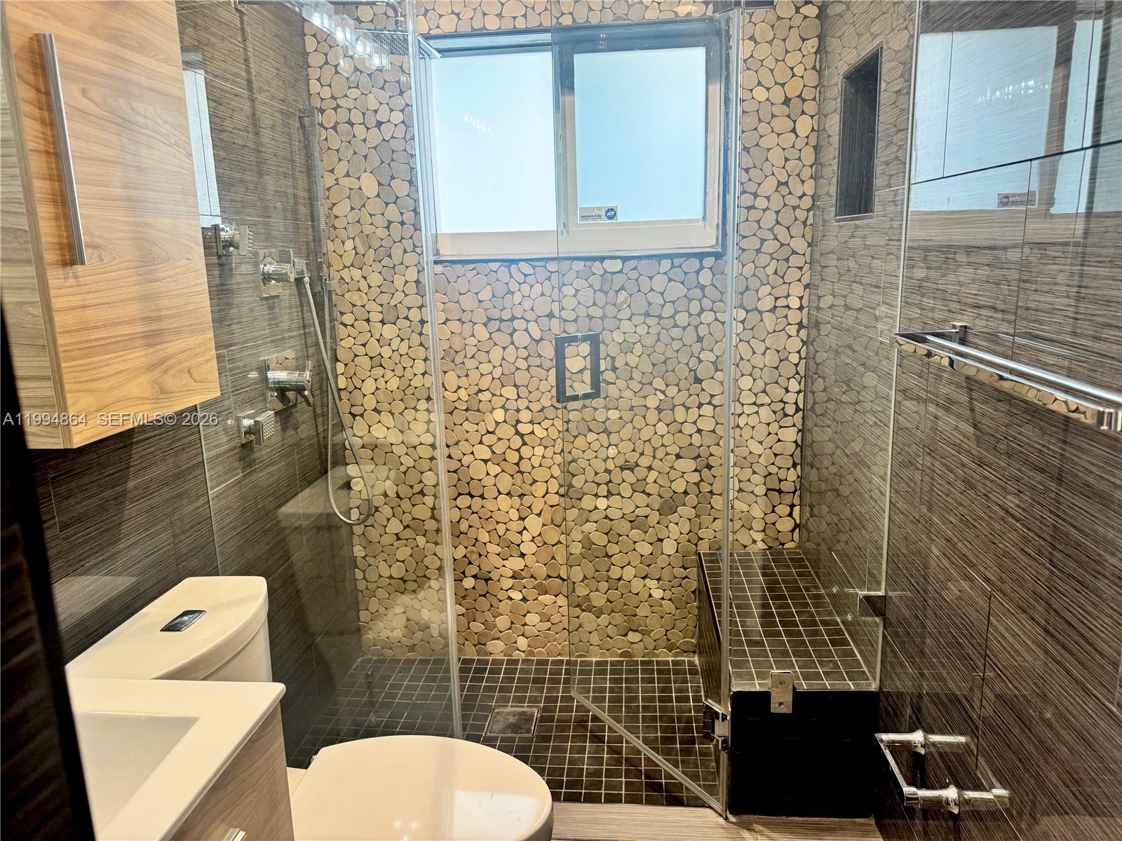 10760 Southwest 63rd Street Miami, FL 33173 - Photo 23 of 61 a bathroom with a toilet and a shower