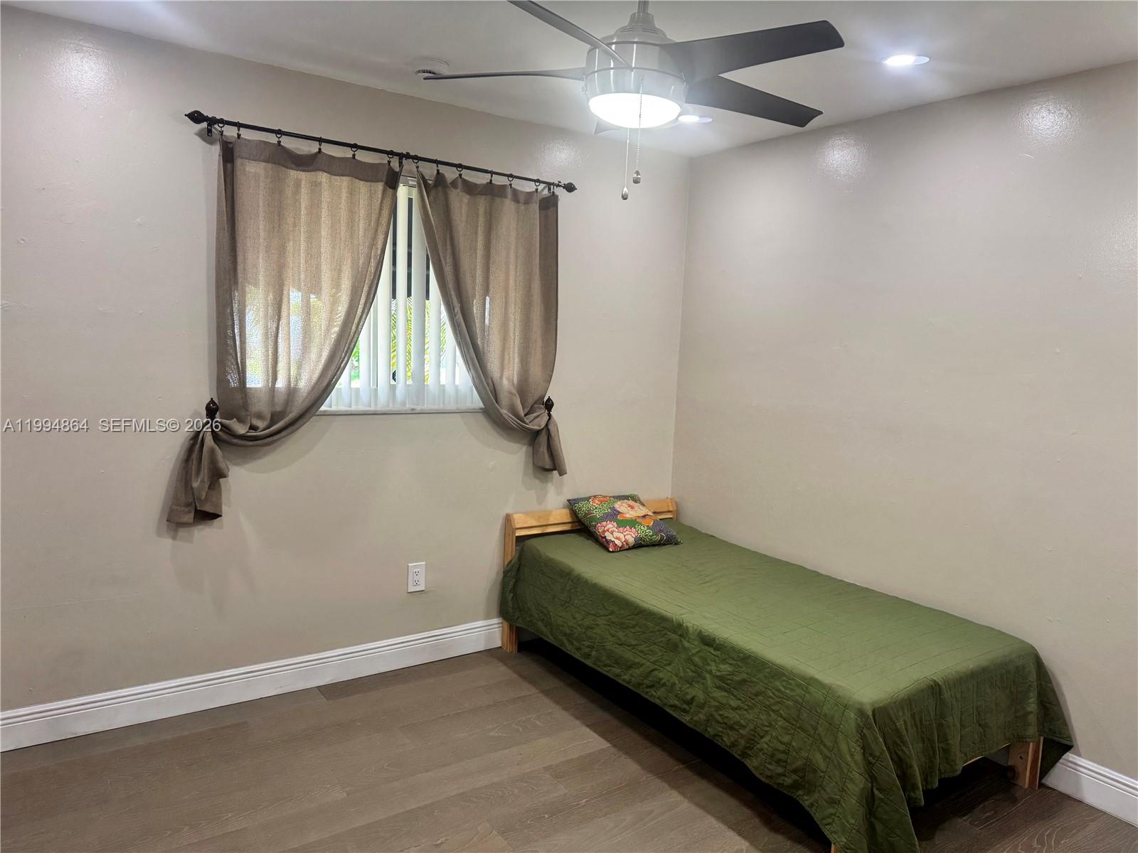 10760 Southwest 63rd Street Miami, FL 33173 - Photo 26 of 61 a bedroom with a bed and a window