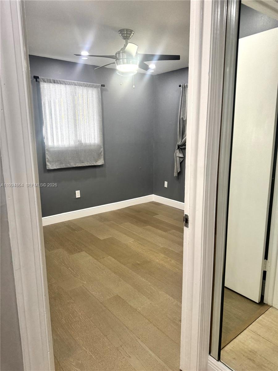 10760 Southwest 63rd Street Miami, FL 33173 - Photo 29 of 61 a view of a livingroom with an empty space and a window