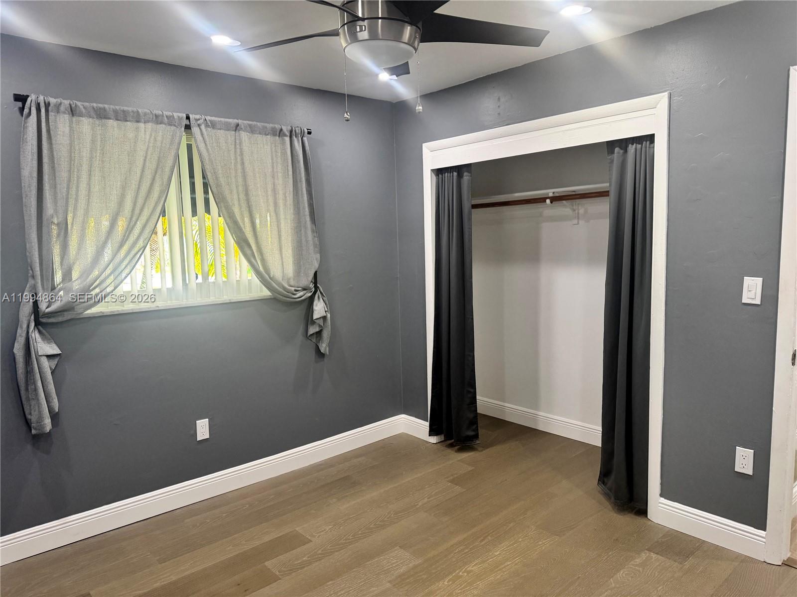 10760 Southwest 63rd Street Miami, FL 33173 - Photo 30 of 61 a view of a hallway with a window and a ceiling fan