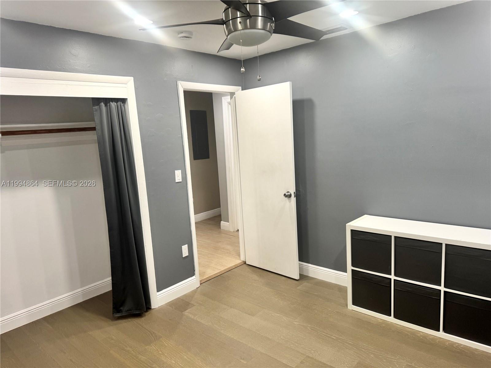 10760 Southwest 63rd Street Miami, FL 33173 - Photo 31 of 61 a view of empty room with wooden floor and fireplace