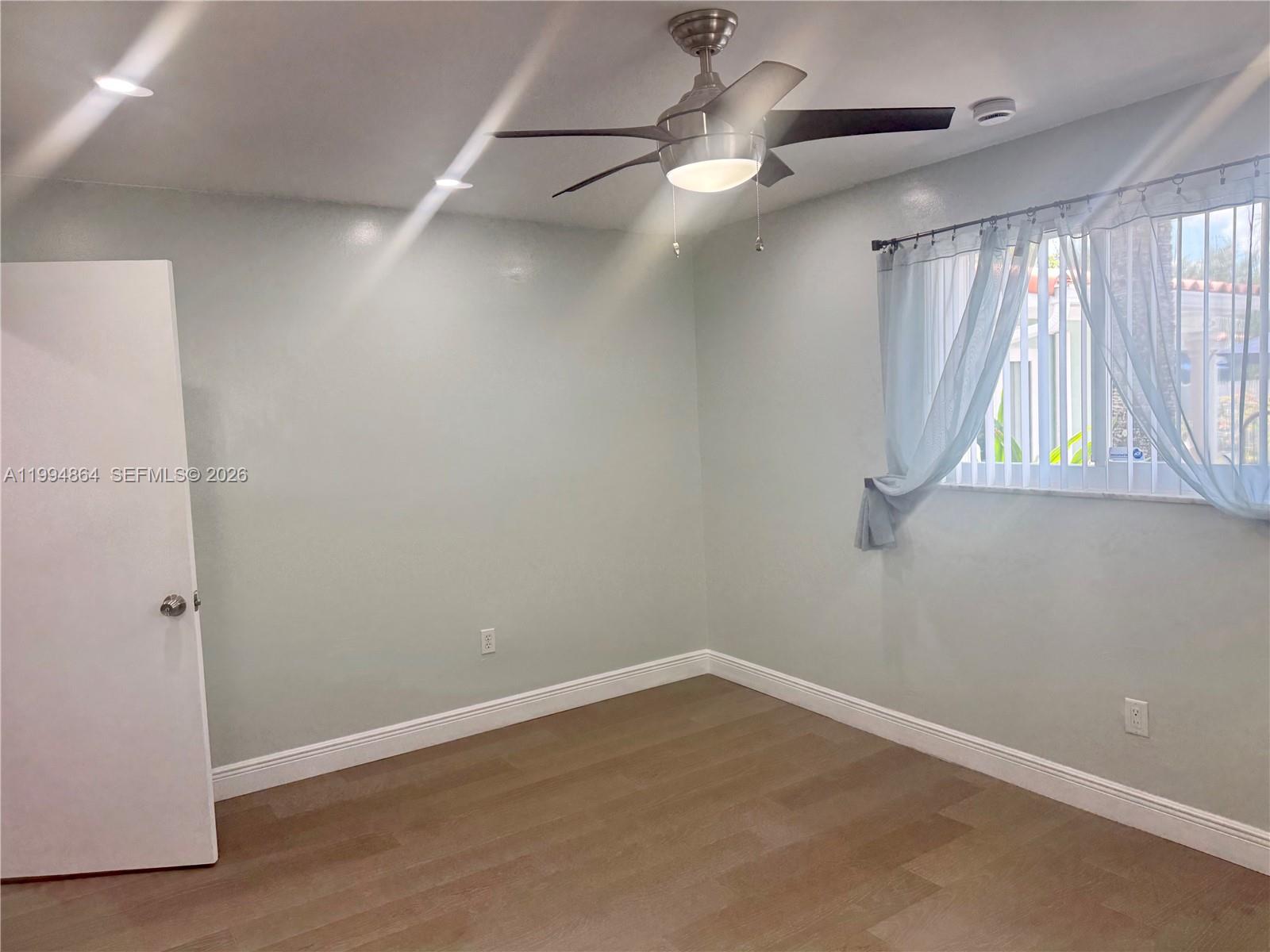 10760 Southwest 63rd Street Miami, FL 33173 - Photo 33 of 61 an empty room with a window