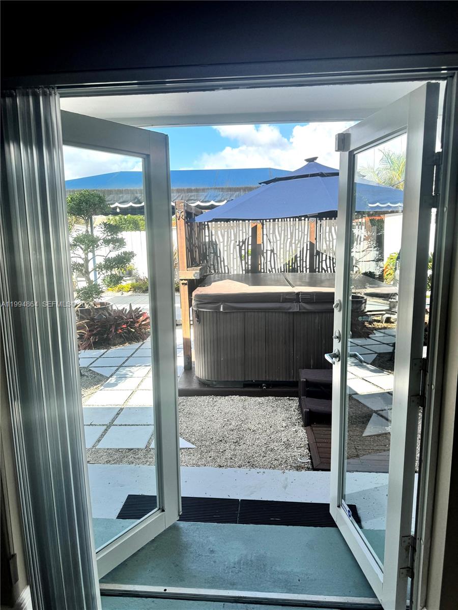 10760 Southwest 63rd Street Miami, FL 33173 - Photo 36 of 61 French doors opening up to backyard