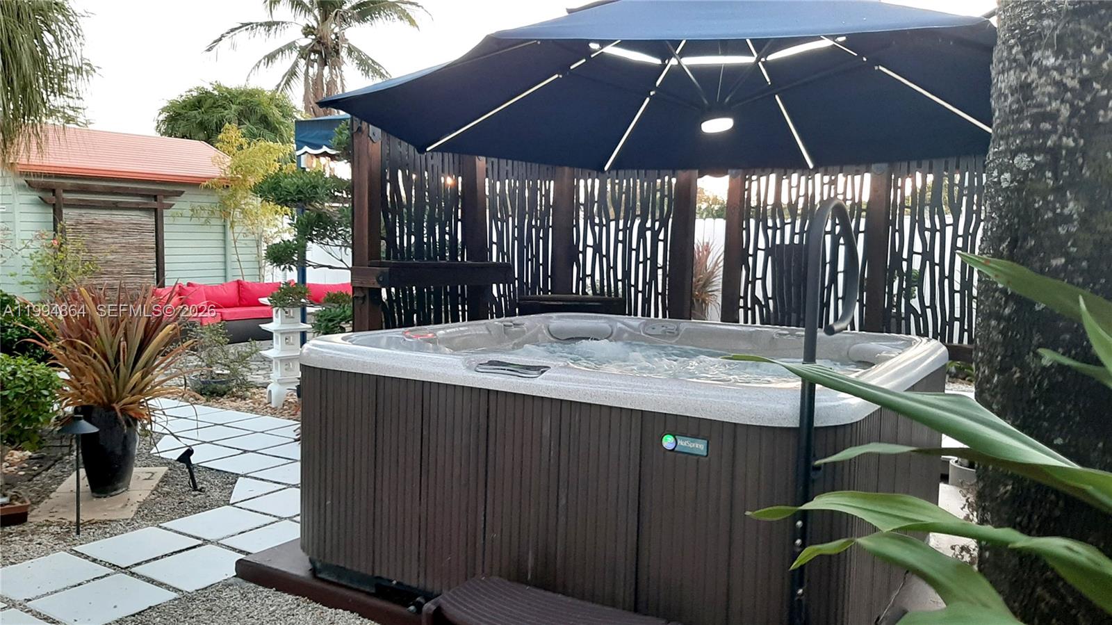 10760 Southwest 63rd Street Miami, FL 33173 - Photo 37 of 61 a view of a patio with table and chairs under an umbrella