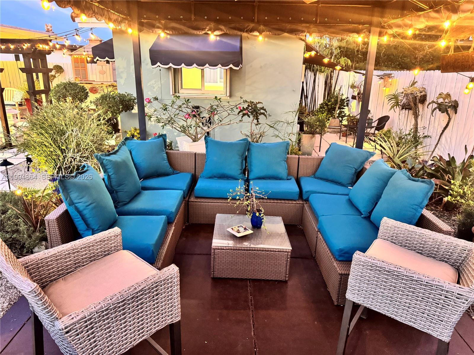 10760 Southwest 63rd Street Miami, FL 33173 - Photo 49 of 61 a outdoor living room with furniture and a rug