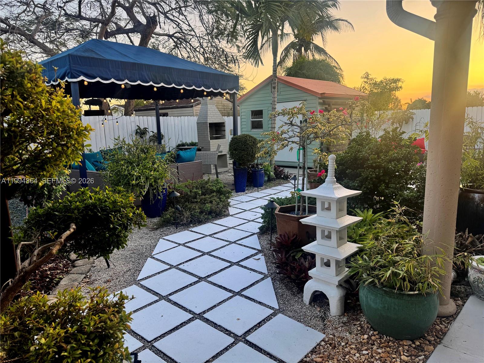 10760 Southwest 63rd Street Miami, FL 33173 - Photo 50 of 61 a view of a house with a garden