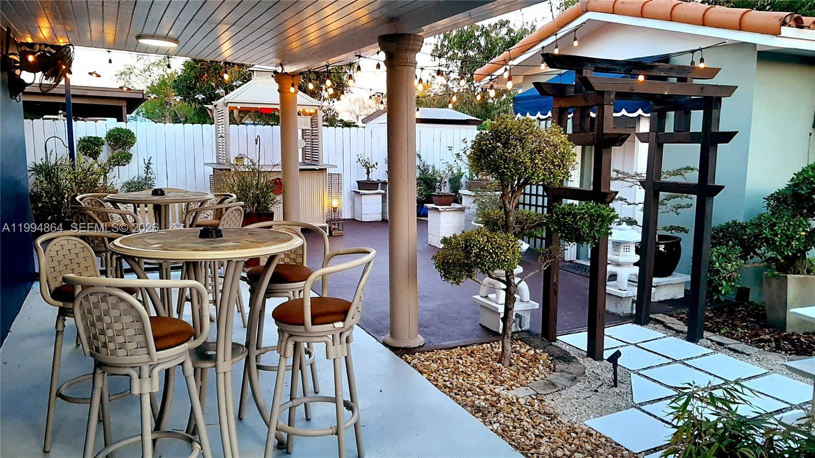 10760 Southwest 63rd Street Miami, FL 33173 - Photo 51 of 61 a view of a patio with table and chairs potted plants