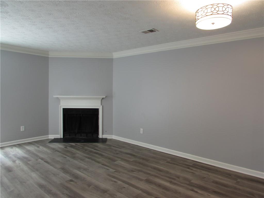 835 Heritage Valley Road Norcross, GA 30093 - Photo 22 of 34 a view of empty room with wooden floor and fireplace
