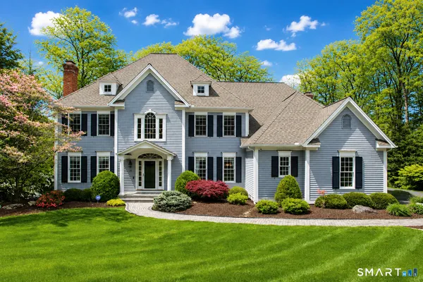 a front view of a house with a yard and porch