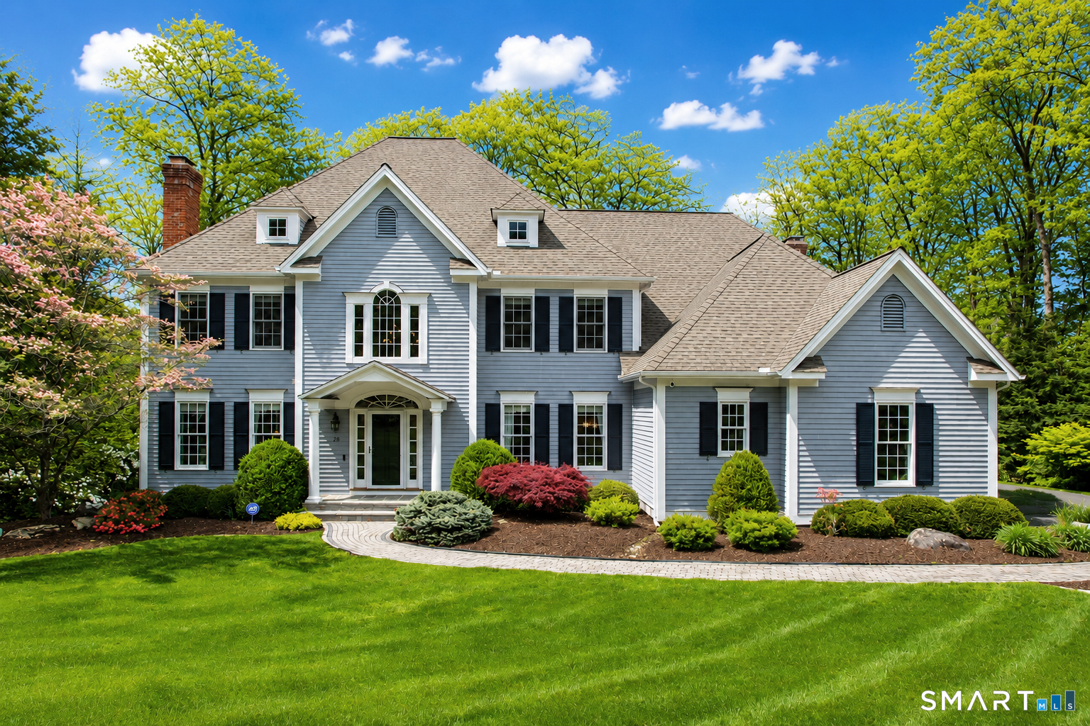 a front view of a house with a yard and porch