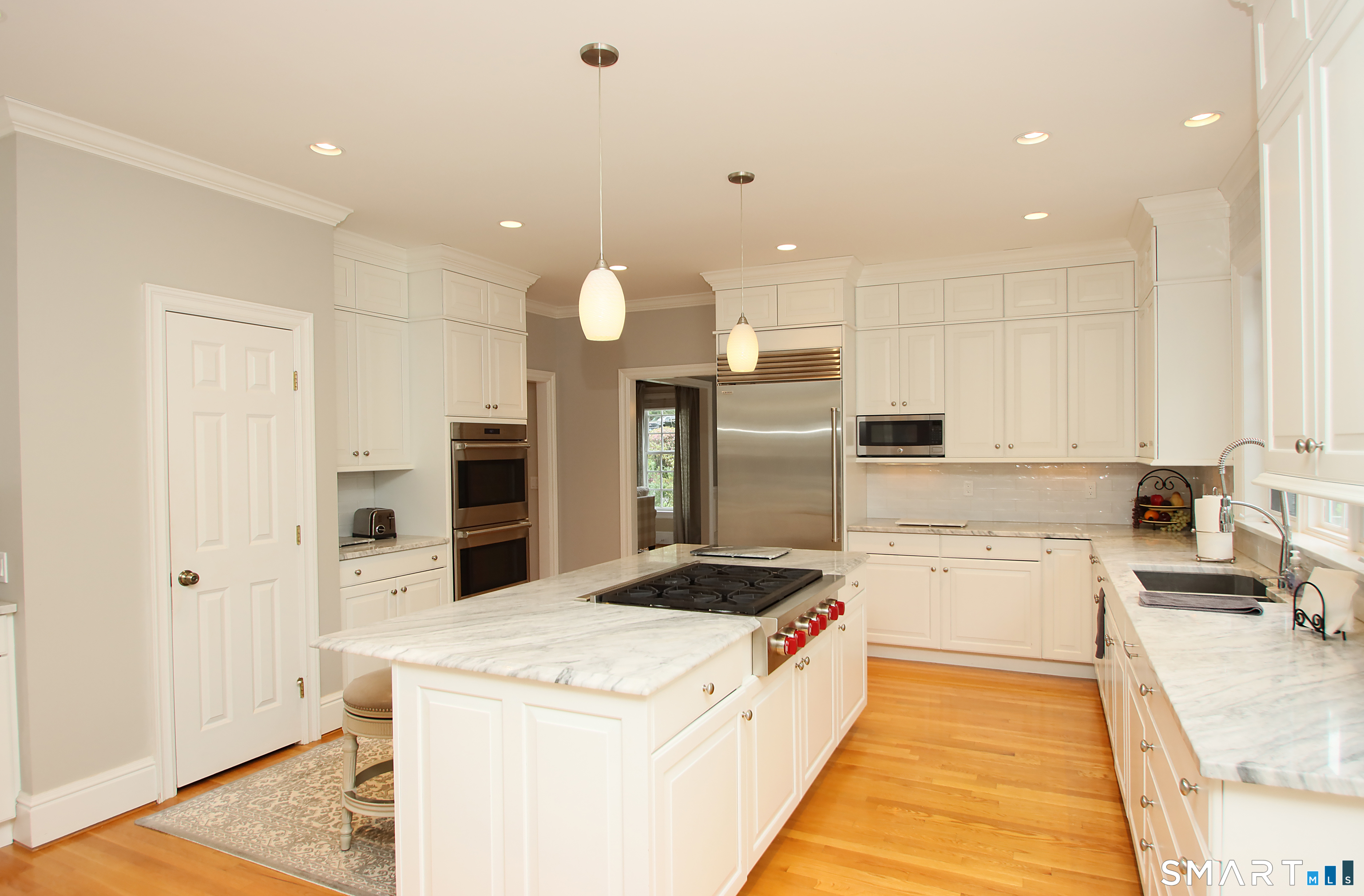 28 Quail Ridge Drive Avon, CT 06001 - Photo 21 of 40 a large kitchen with stainless steel appliances kitchen island granite countertop a sink and cabinets