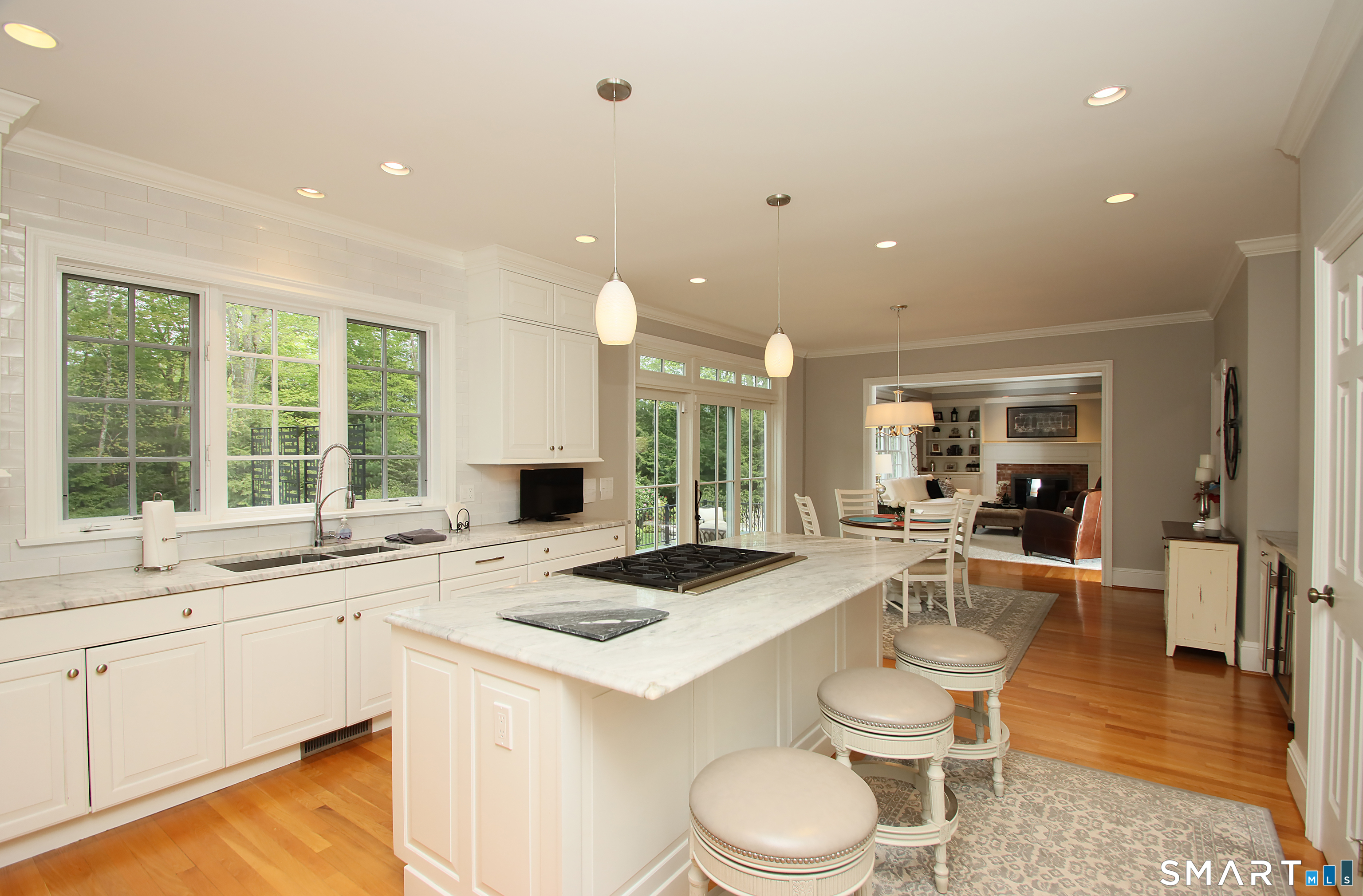 28 Quail Ridge Drive Avon, CT 06001 - Photo 22 of 40 a kitchen with a stove a sink a dining table and chairs