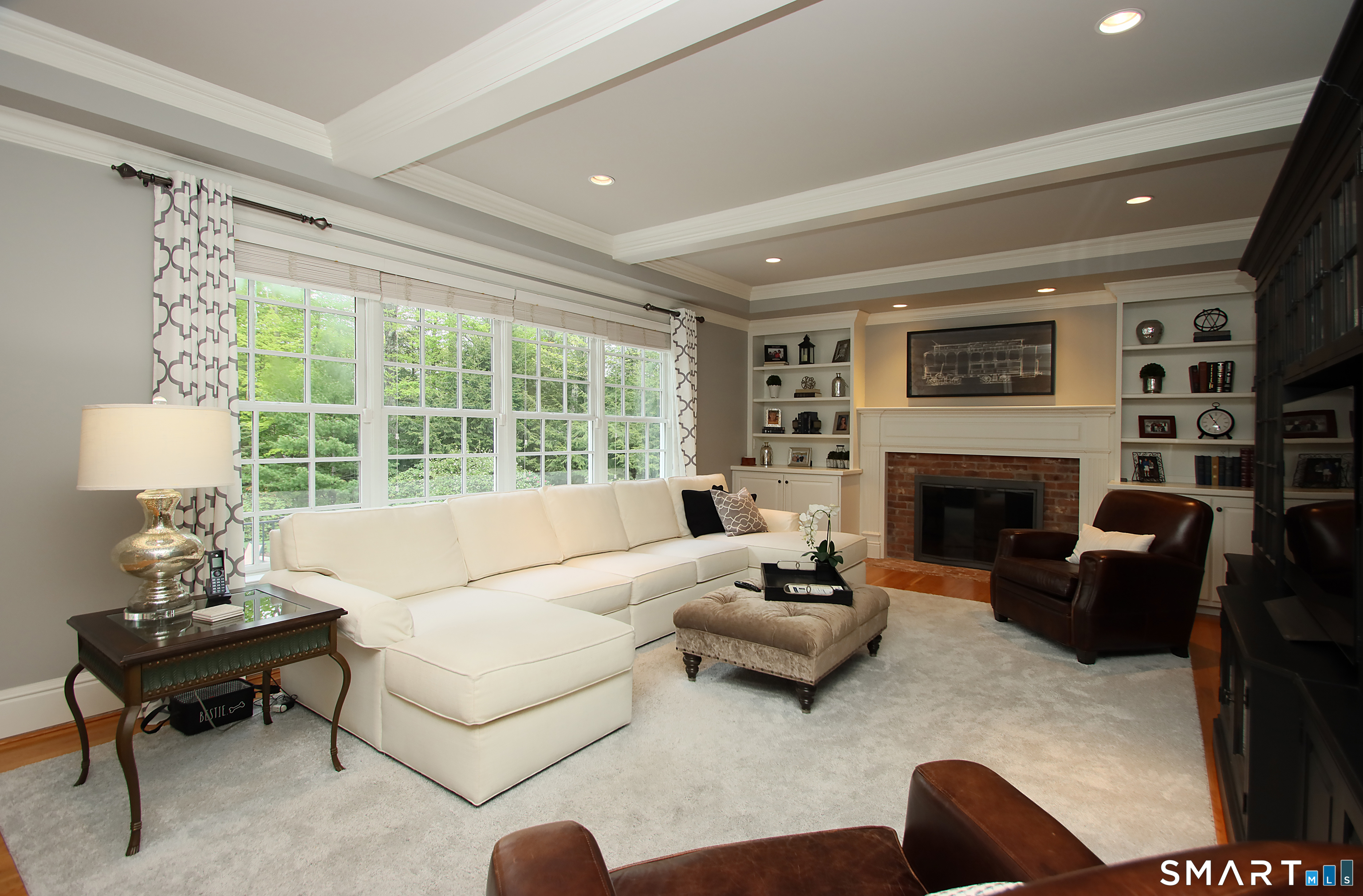 28 Quail Ridge Drive Avon, CT 06001 - Photo 24 of 40 a living room with furniture large window and a fireplace