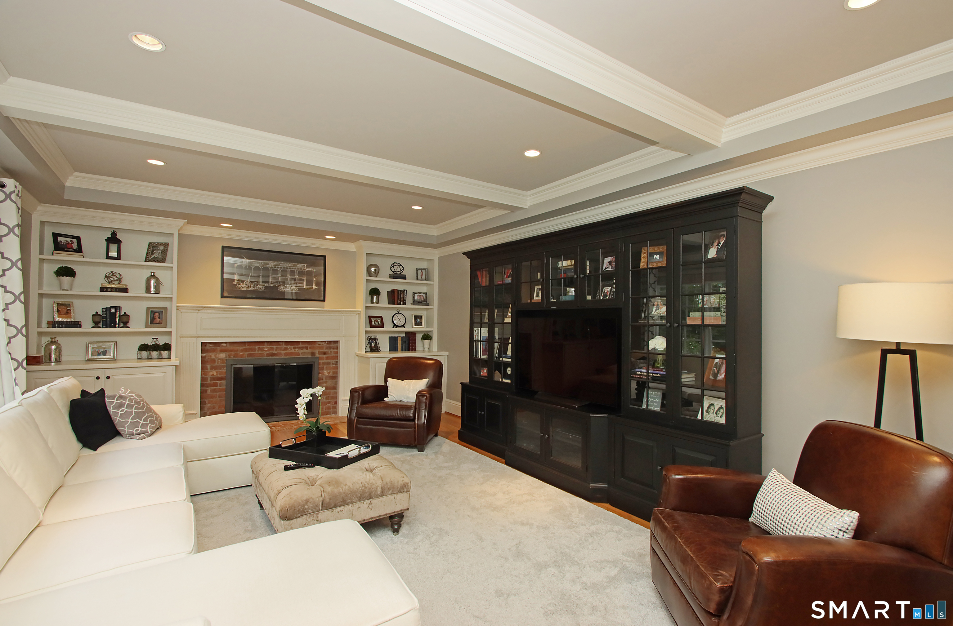 28 Quail Ridge Drive Avon, CT 06001 - Photo 25 of 40 a living room with furniture a lamp and a fireplace