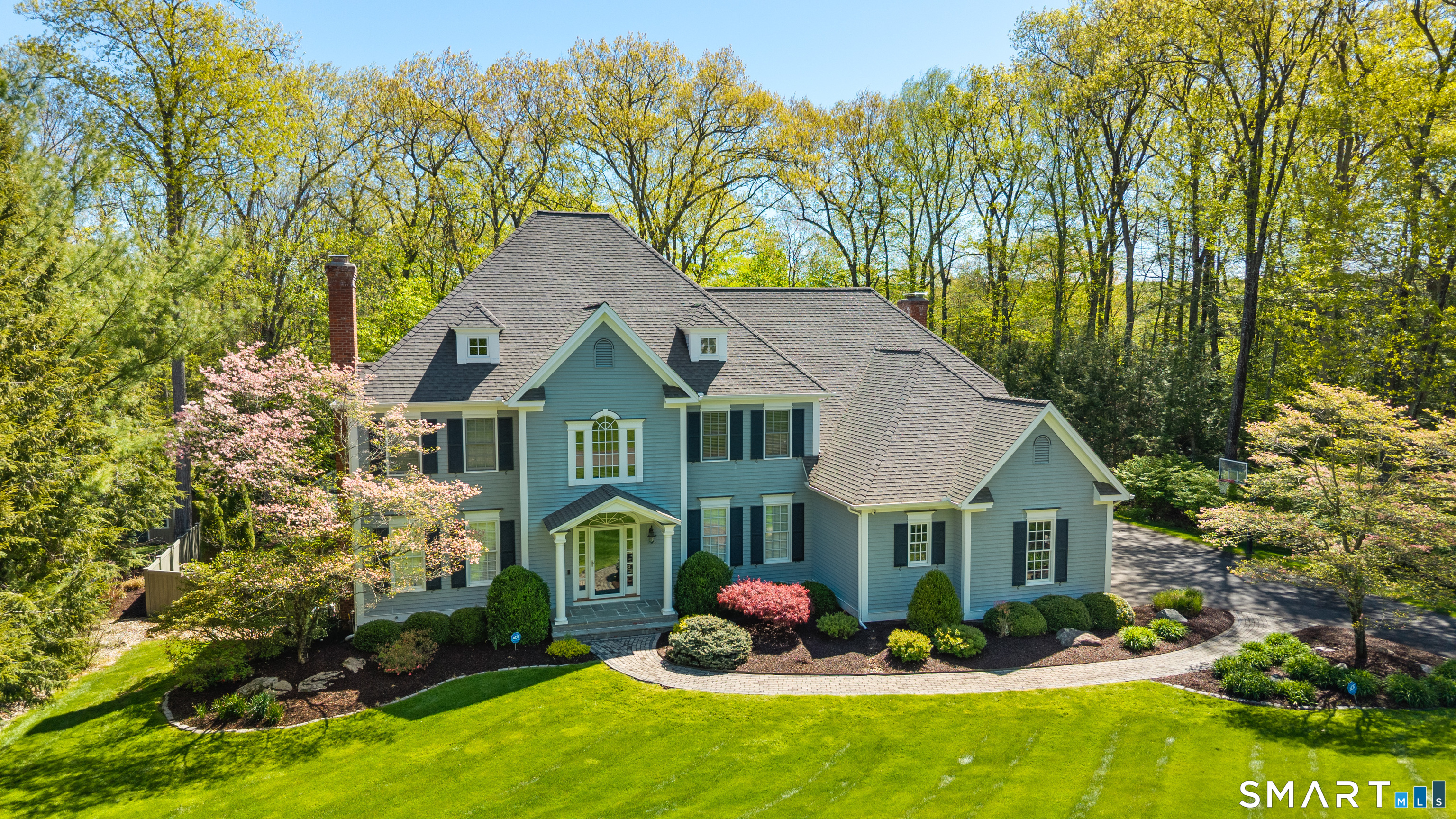 28 Quail Ridge Drive Avon, CT 06001 - Photo 3 of 40 a front view of house with yard and trees in the background