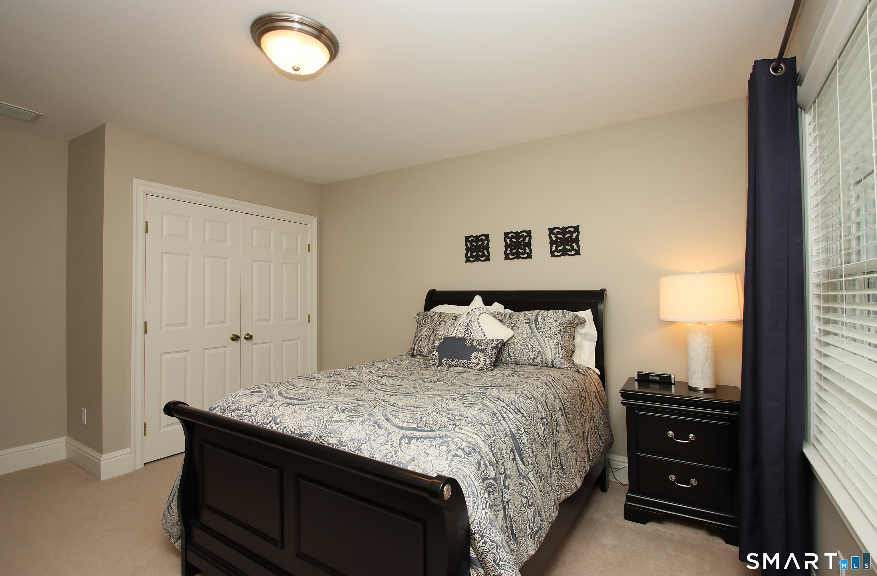 28 Quail Ridge Drive Avon, CT 06001 - Photo 32 of 40 a spacious bedroom with a bed and a window