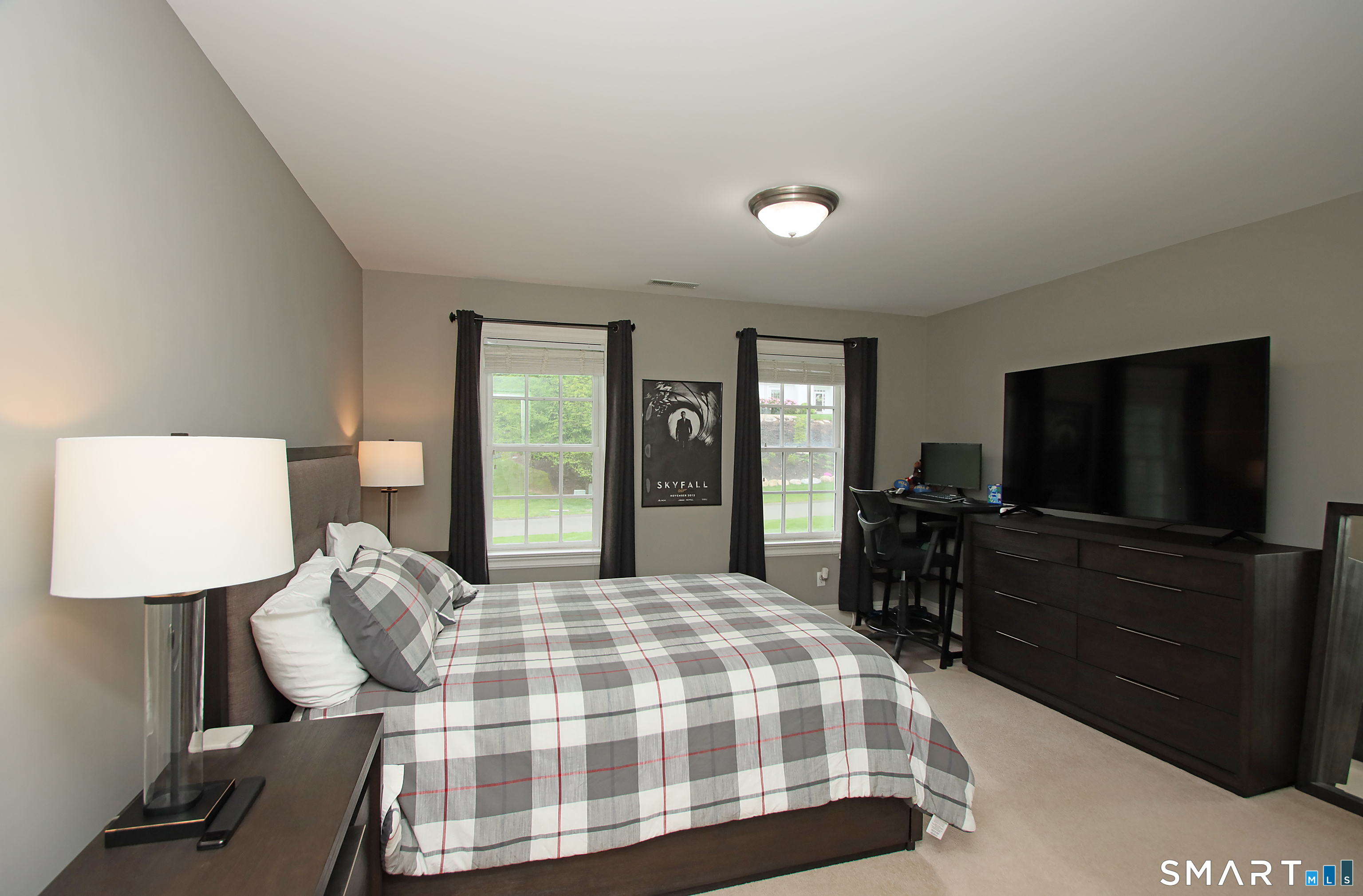28 Quail Ridge Drive Avon, CT 06001 - Photo 35 of 40 a bedroom with a bed and a flat screen tv