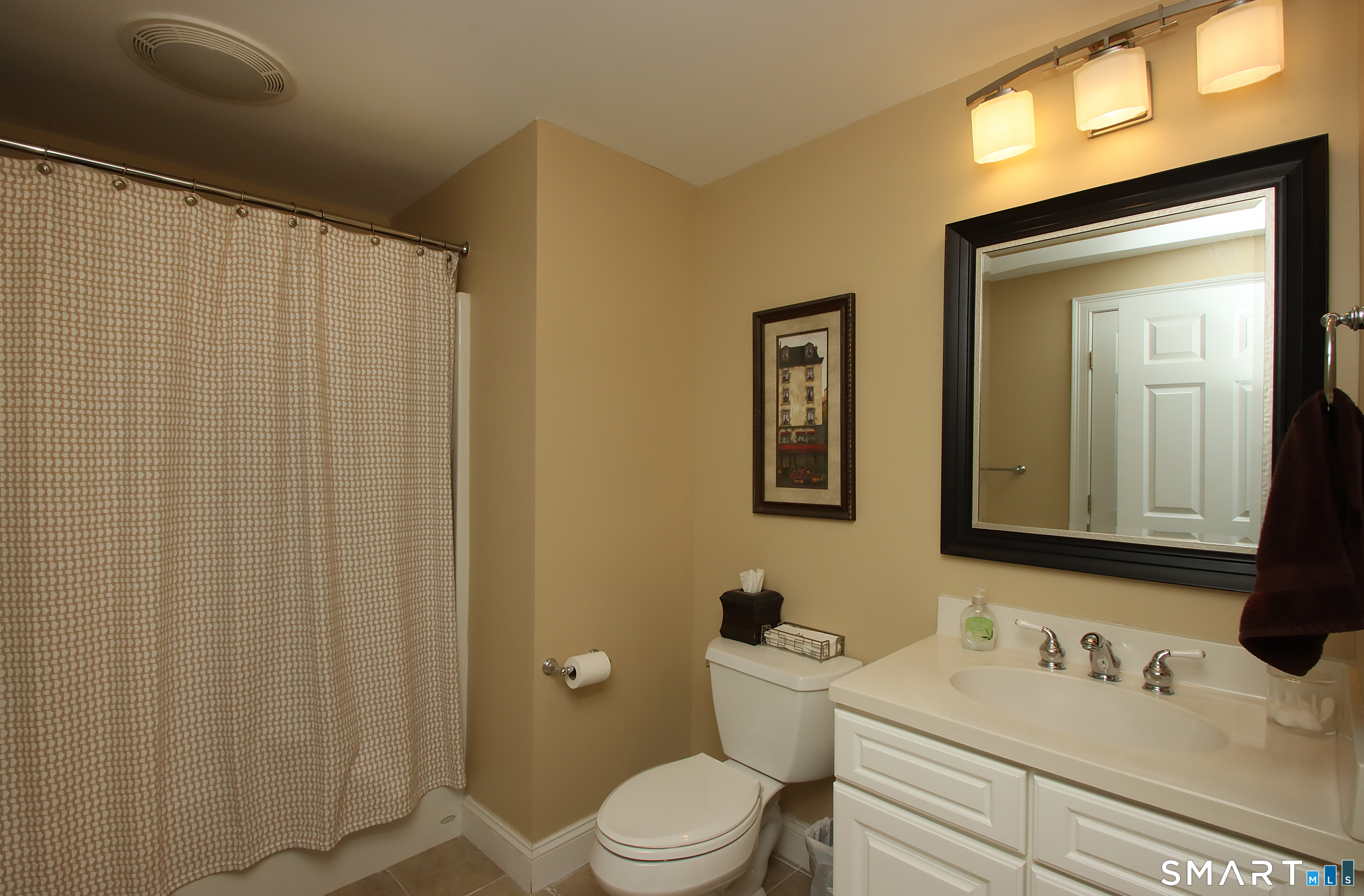 28 Quail Ridge Drive Avon, CT 06001 - Photo 39 of 40 a bathroom with a sink a toilet and mirror