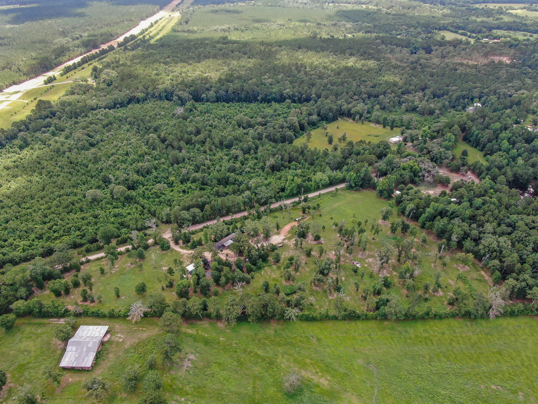 400 Raven Hill Road Oakhurst, TX 77359 - Photo 39 of 45 a view of a green yard with large trees