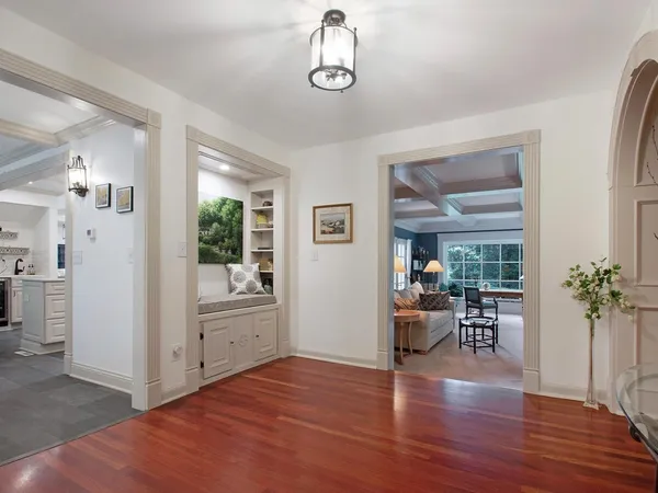 a view of a kitchen with fridge and wooden floor