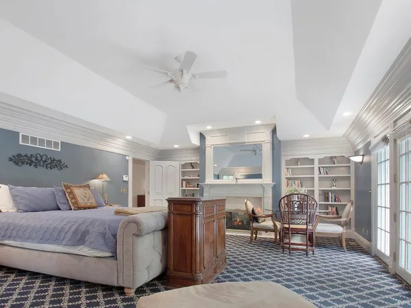 a bedroom with a bed and glass wall