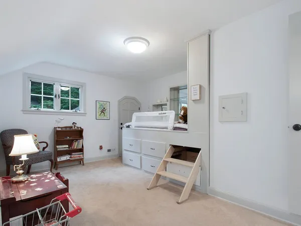 a view of a white house with large trees