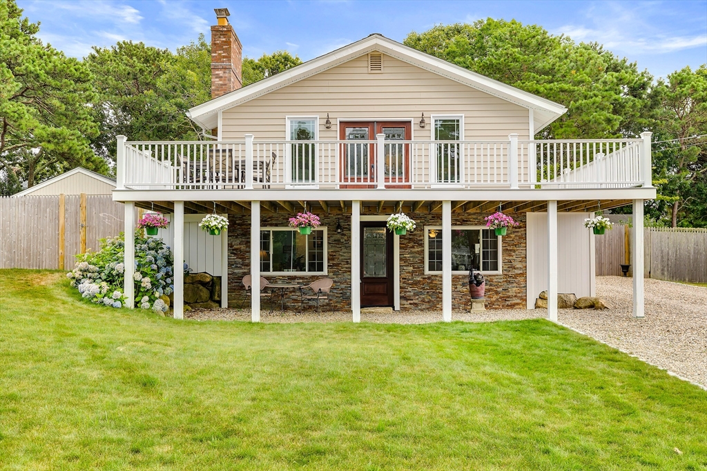 100 Madeline Road Falmouth, MA 02536 - Photo 7 of 29 a front view of a house with a yard and porch