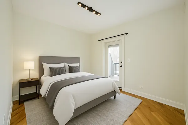 a bedroom with a bed and a night stand