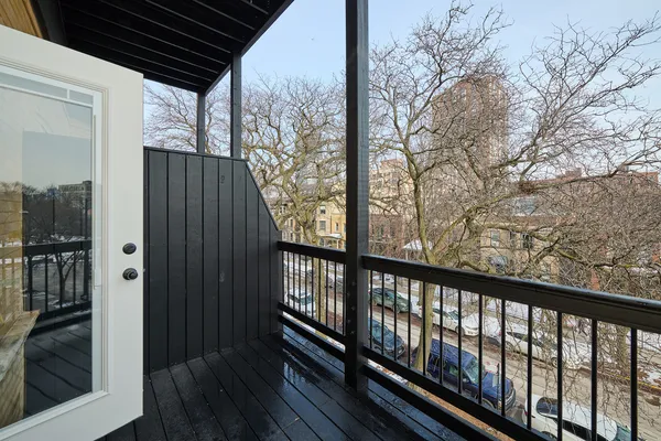 a view of balcony with wooden floor and fence and floor