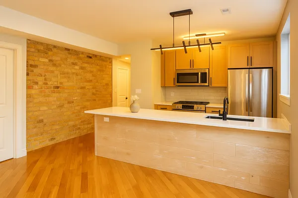 a bathroom with a granite countertop sink and a bathtub