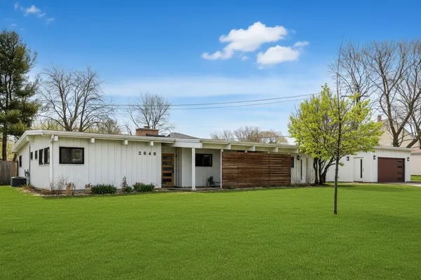 a front view of house with yard and green space