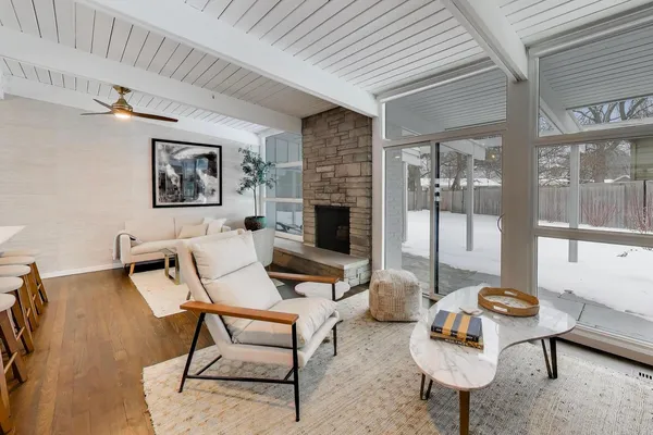 a living room with furniture a dining table and a fireplace