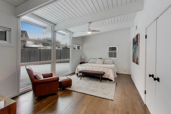 a bedroom with furniture and a wooden floor