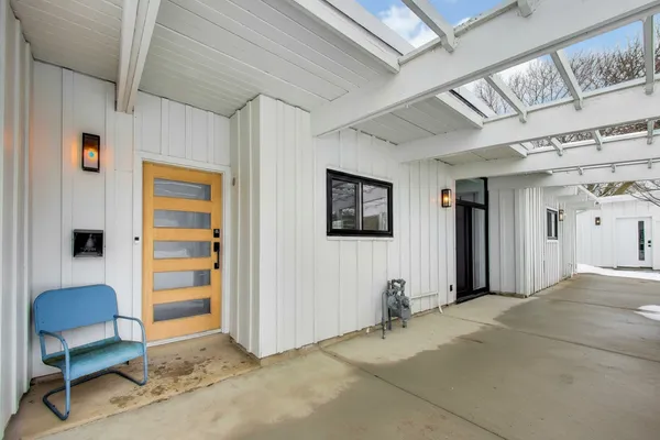 a view of a livingroom with furniture and a window