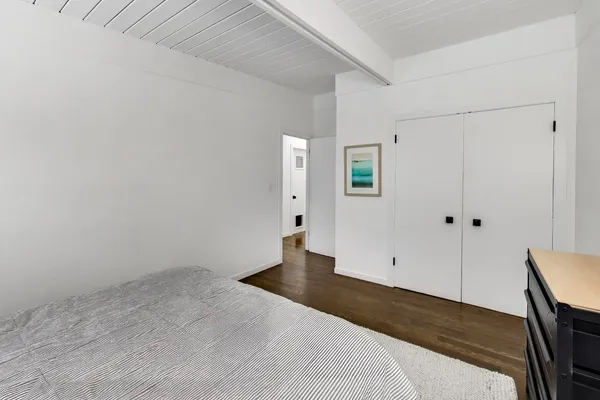 a bedroom with a bed and glass door