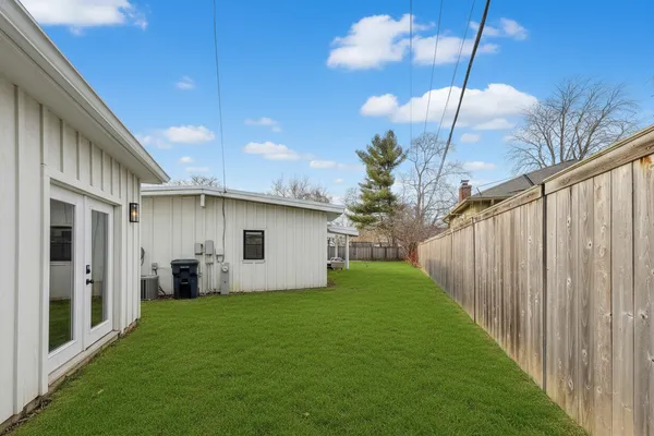 a view of a house with backyard and porch