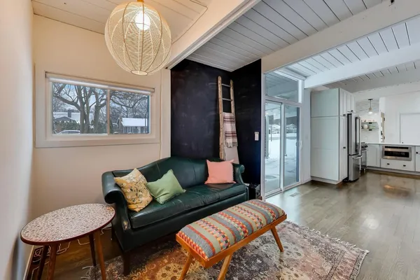 a living room with furniture and a chandelier