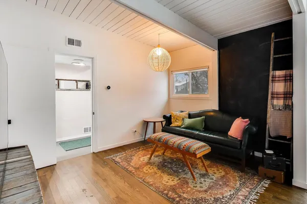 a living room with furniture and a wooden floor