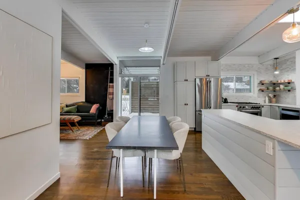 a kitchen with stainless steel appliances a stove a sink and a refrigerator