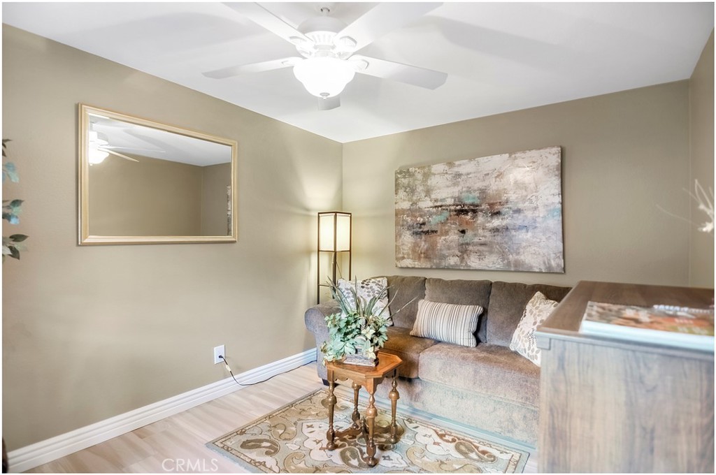 33766 Captains Lane, Unit 200 Dana Point, CA 92629 - Photo 19 of 38 a living room with furniture and a chandelier