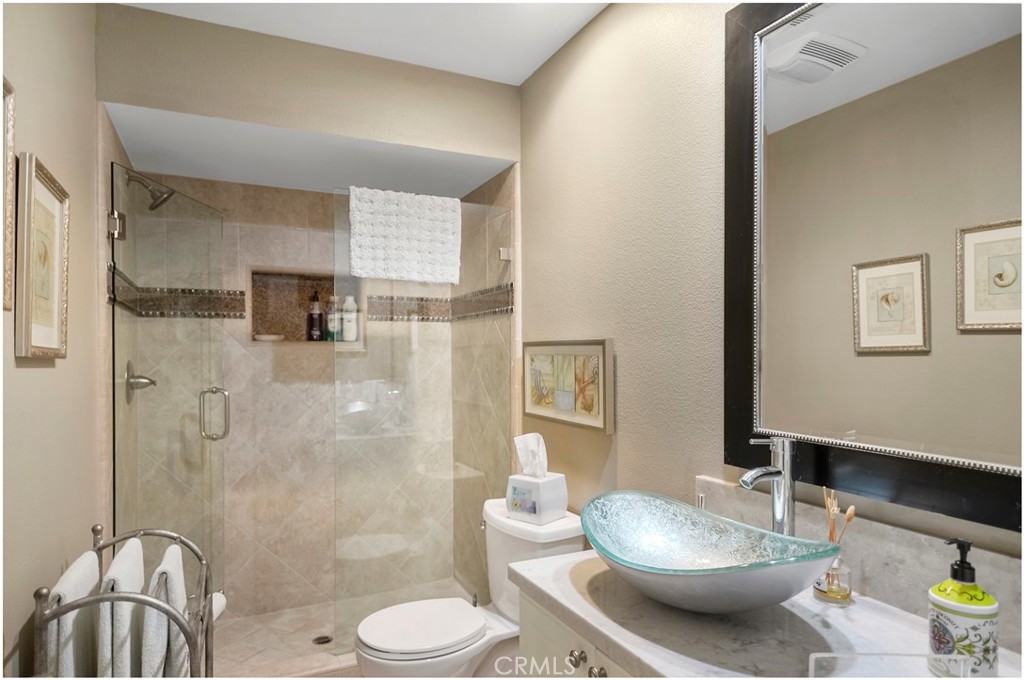 33766 Captains Lane, Unit 200 Dana Point, CA 92629 - Photo 20 of 38 a bathroom with a granite countertop sink toilet and shower