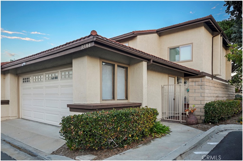 33766 Captains Lane, Unit 200 Dana Point, CA 92629 - Photo 2 of 38 a front view of a house with garage
